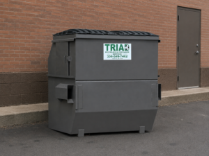 8 yard commercial dumpster rental behind a retail building in Winston-Salem NC